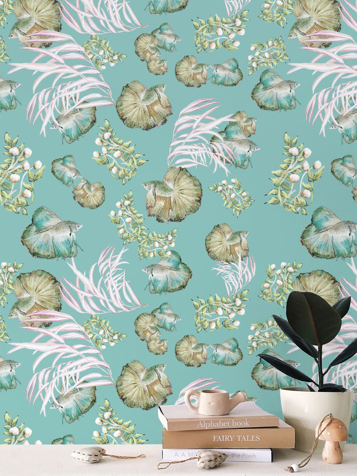Seashell and seaweed pattern with fish on a teal background with books and a plant in the foreground.
