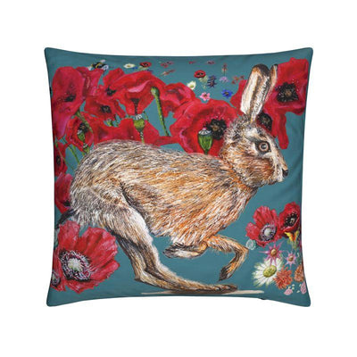 Decorative pillow with a rabbit and floral design on a teal background