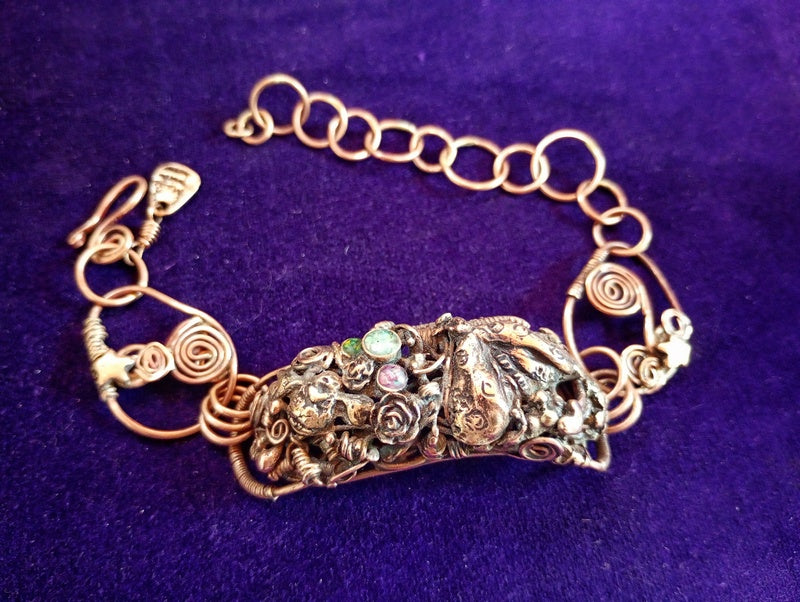 Decorative bracelet with intricate design on a purple background