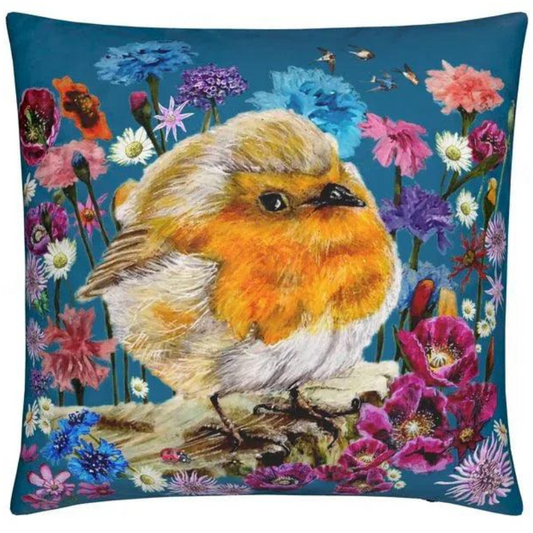 Decorative pillow with a robin and floral design on a blue background