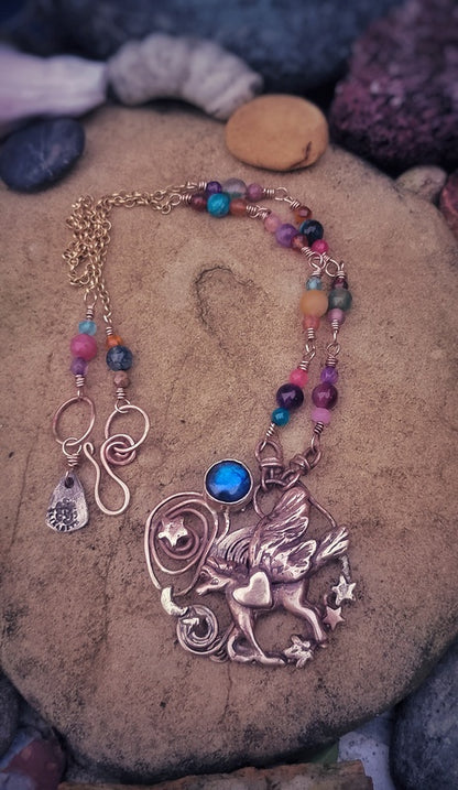 Necklace with a detailed pendant on a stone surface