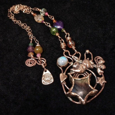 Bronze necklace with a labradorite pendant and colorful beads by artist Elizabeth Shewan Silversmith on a black background