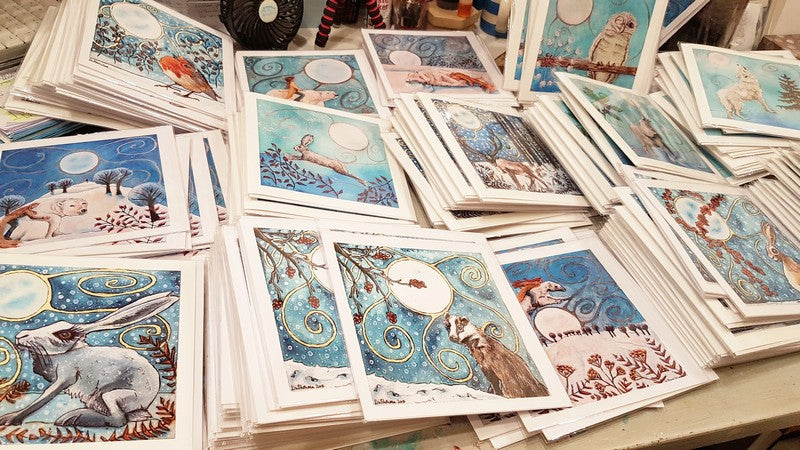 Collection of tarot cards with artistic designs on a table.