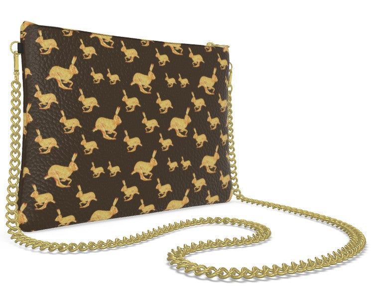Brown clutch bag with gold rabbit pattern and matching chain strap on a white background