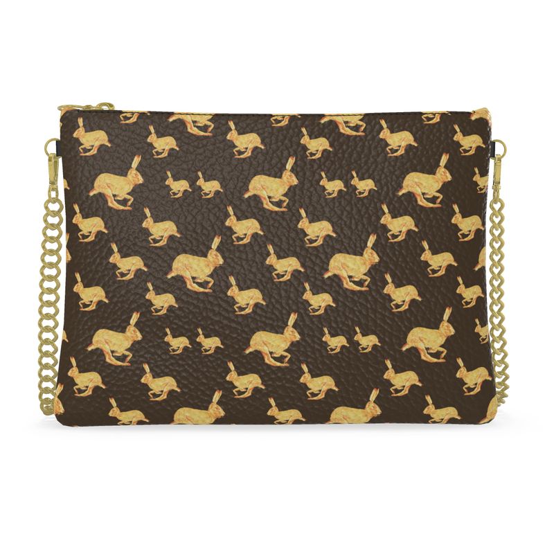Clutch bag with gold rabbit pattern on a brown background