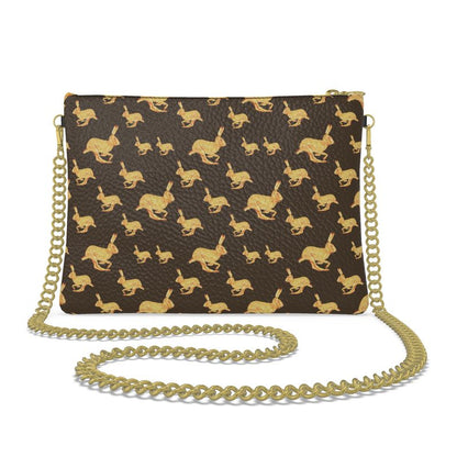 Handbag with gold rabbit pattern and gold chain strap on a white background
