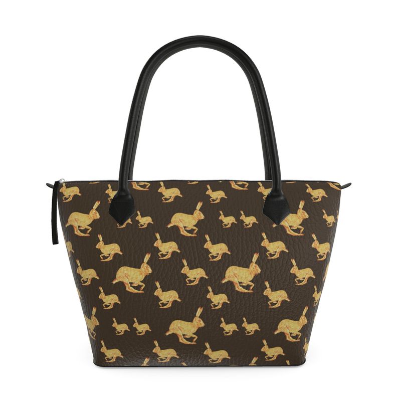 Handbag with gold rabbit pattern on brown background