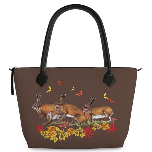 Brown handbag with hare butterfly rabbit and leaf design on a white background
