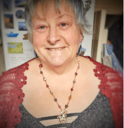 Person wearing a red sweater with a blurred background
