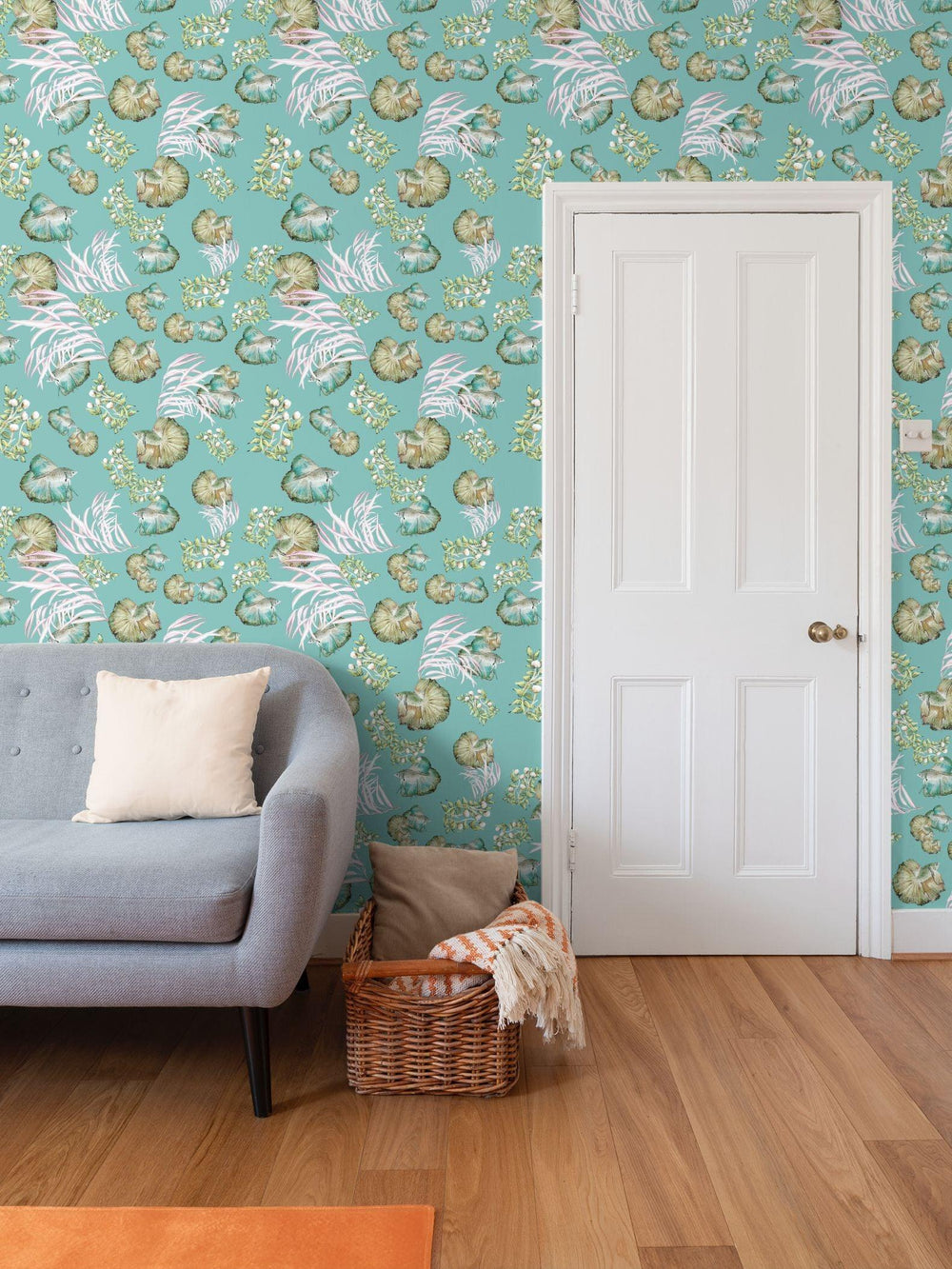 Living room with sea water pond scene fish loral wallpaper, gray sofa, and orange rug.