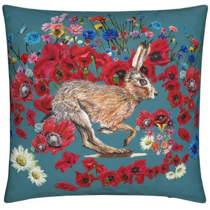 Decorative pillow with a rabbit and floral design on a teal background